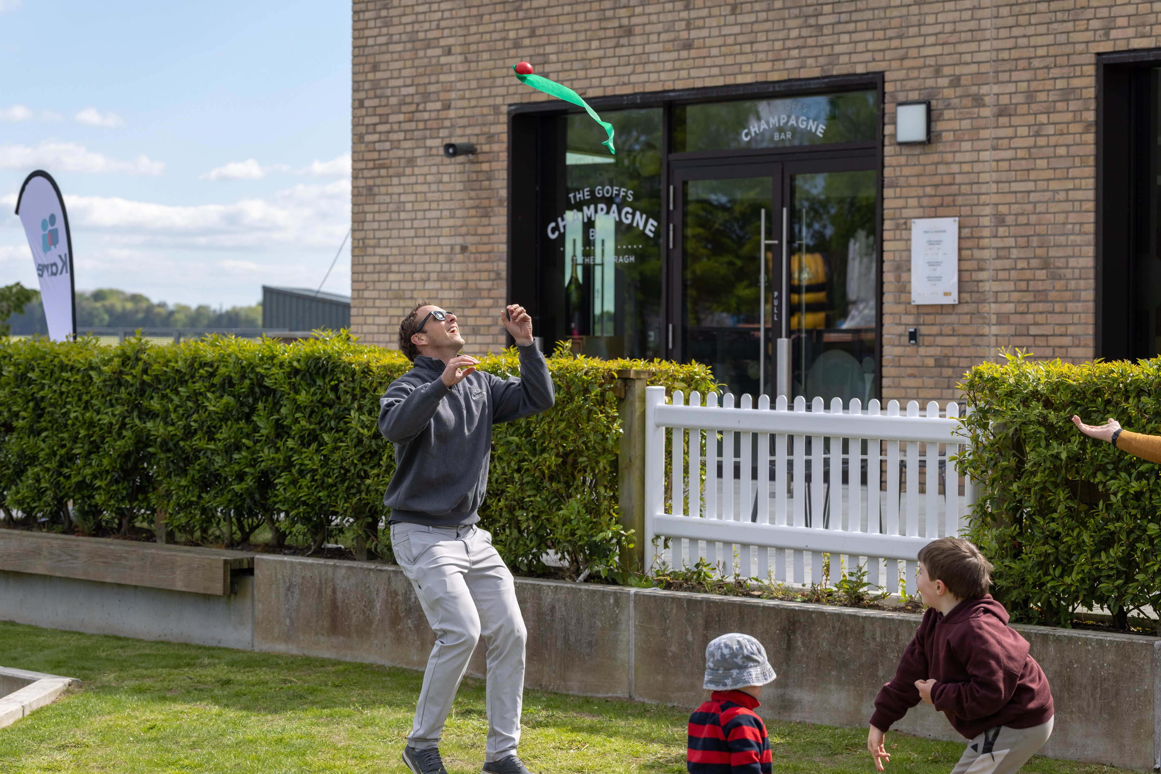 People playing with a toy on the grass. 